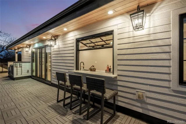 a view of a chairs and table in the balcony