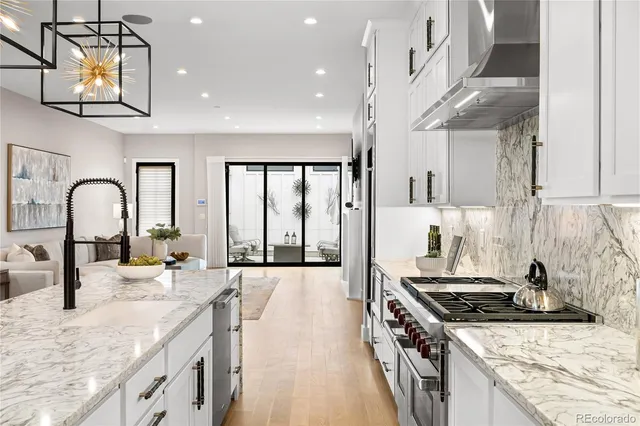 a kitchen with stainless steel appliances granite countertop a stove and a sink