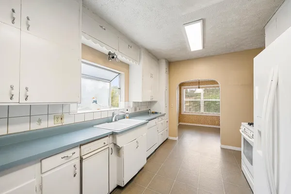 a balcony with wooden floor table and chairs