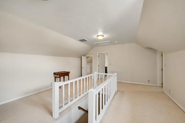 an aerial view of a house with yard and lake view
