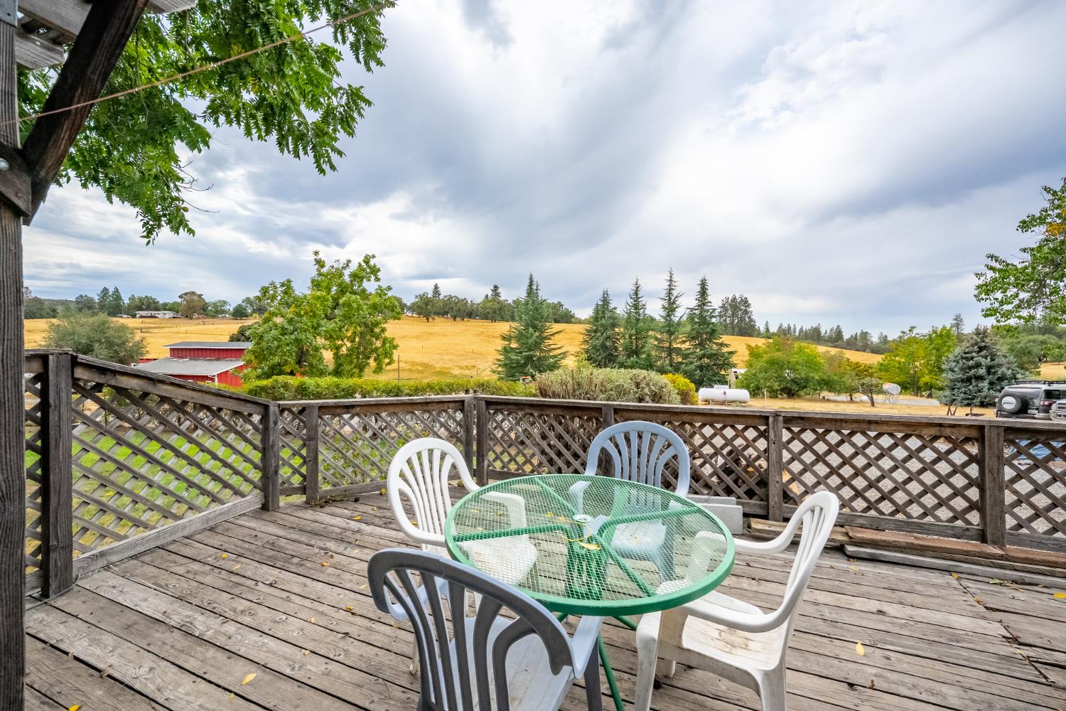 6340 Grizzly Flat Road Somerset, CA 95684 - Photo 67 of 92 a balcony with wooden floor table and chairs