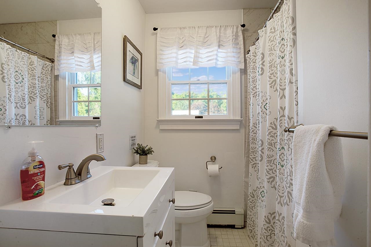 1015 Shunpike Road Cape May, NJ 08204 - Photo 17 of 34 a bathroom with a sink a toilet and shower