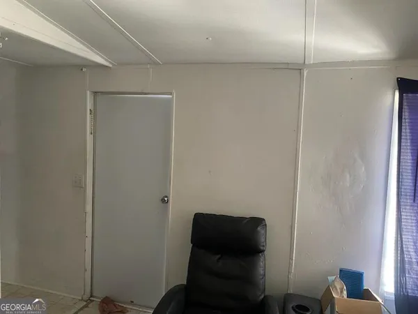 a room with a chair and wooden floor