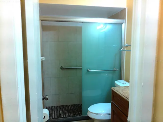 a bathroom with a toilet and a shower