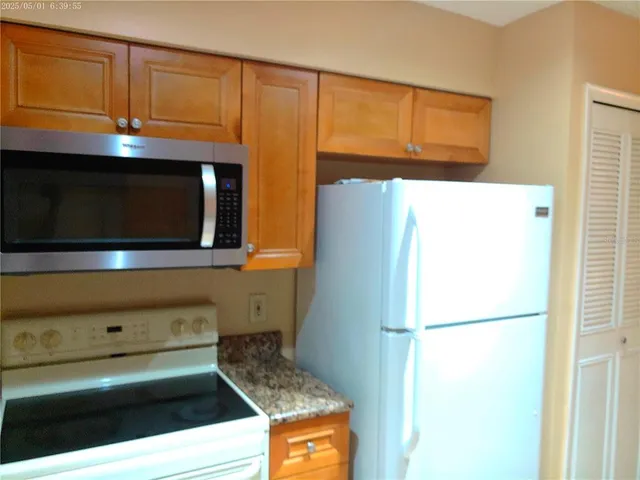 a kitchen with a refrigerator and cabinets