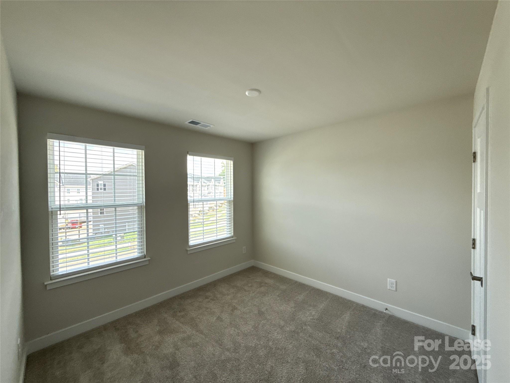 422 Serenity Circle Cramerton, NC 28032 - Photo 14 of 15 an empty room with windows