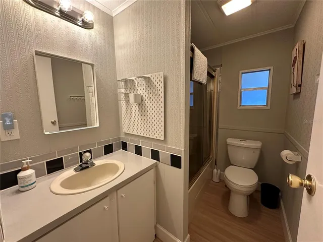 a bathroom with a sink toilet and mirror