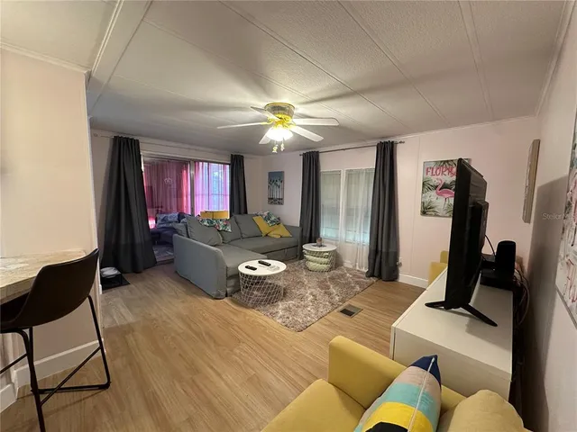 a living room with furniture and a chandelier
