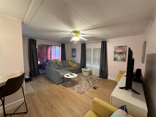 a living room with furniture and a chandelier