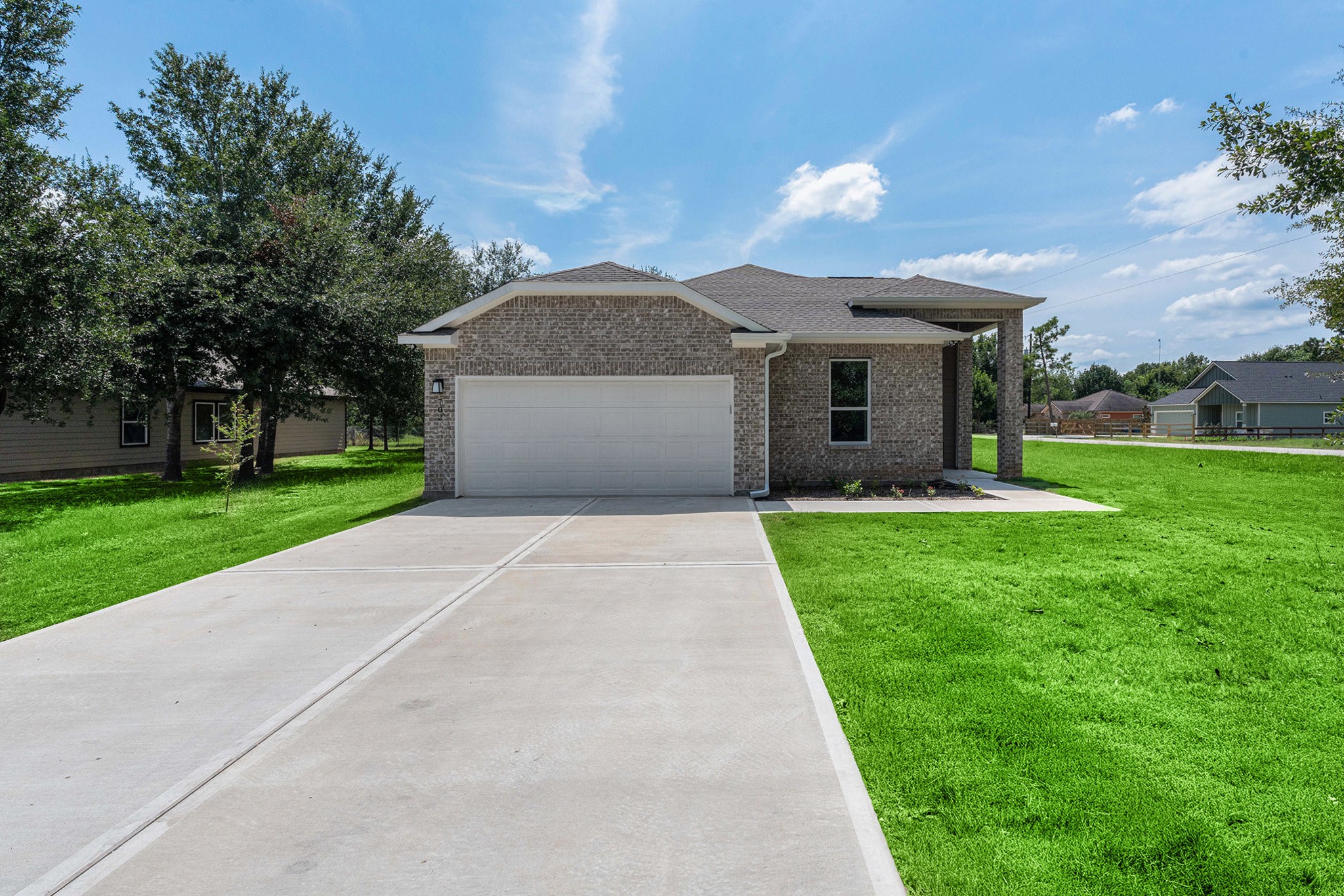 a front view of house with yard and green space