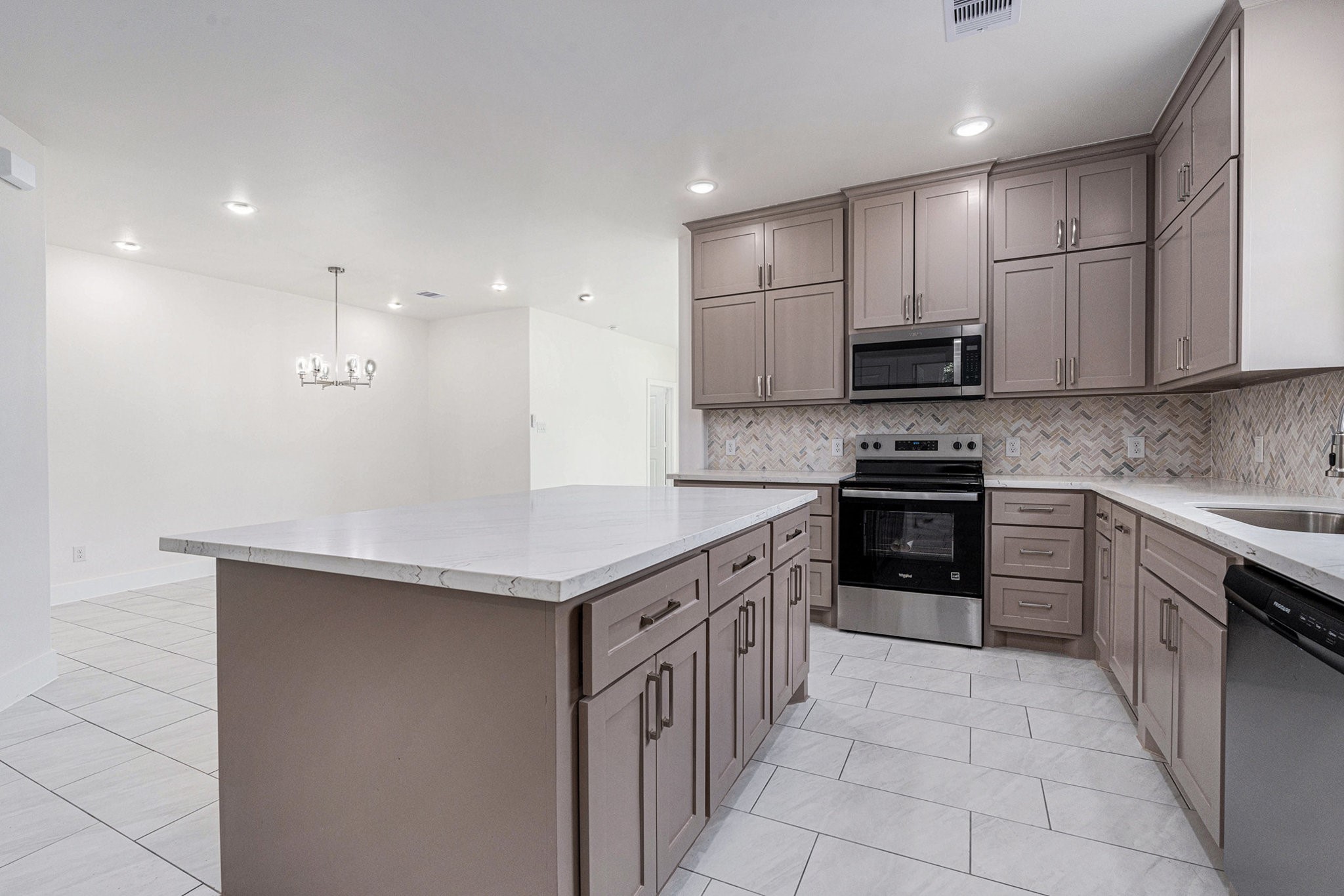702 Azalea Street Waller, TX 77484 - Photo 13 of 45 a kitchen with stainless steel appliances granite countertop a sink stove and cabinets