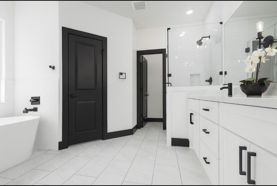 702 Azalea Street Waller, TX 77484 - Photo 25 of 45 a spacious bathroom with a bathtub sink and mirror