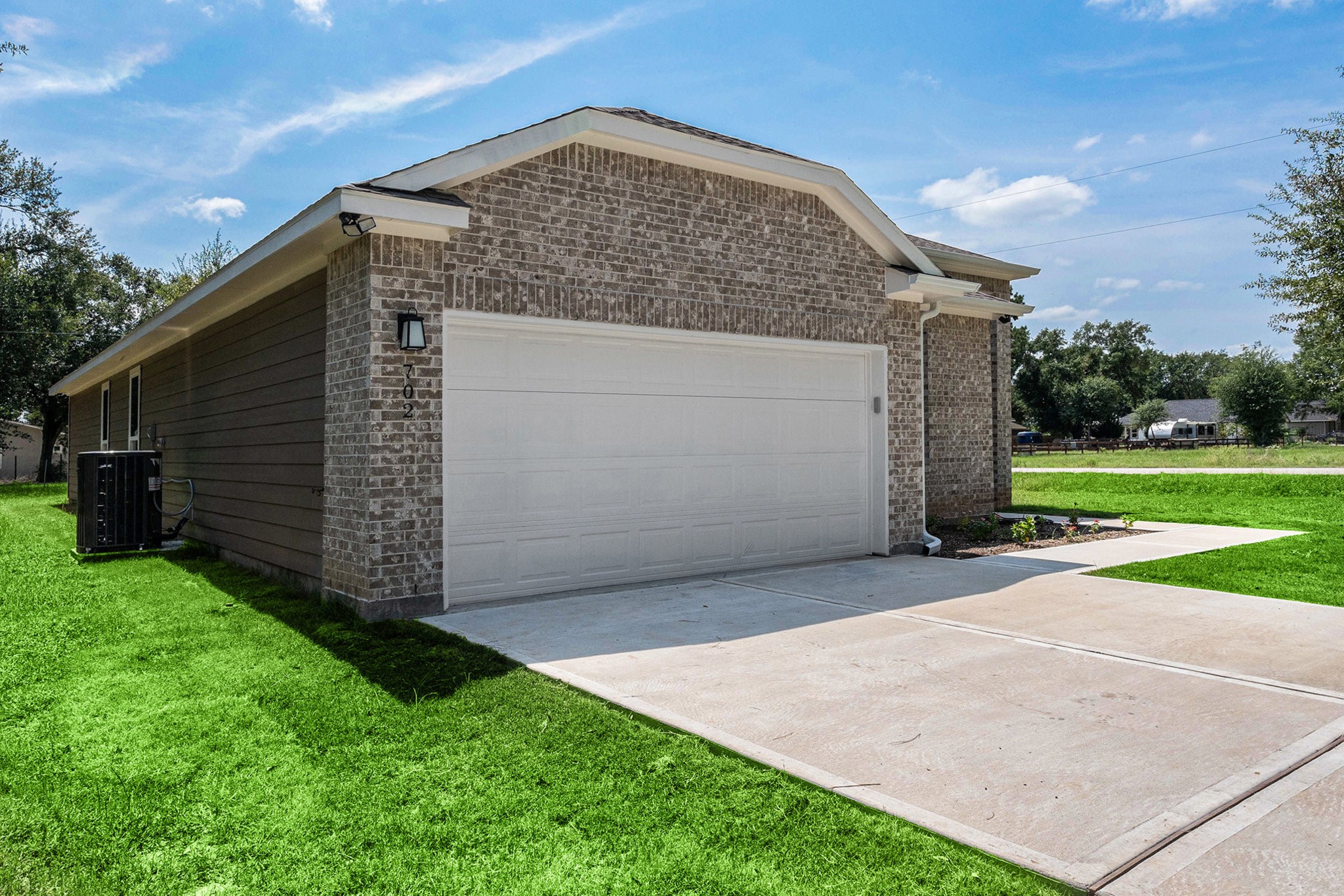 702 Azalea Street Waller, TX 77484 - Photo 3 of 45 a front view of a house with garden