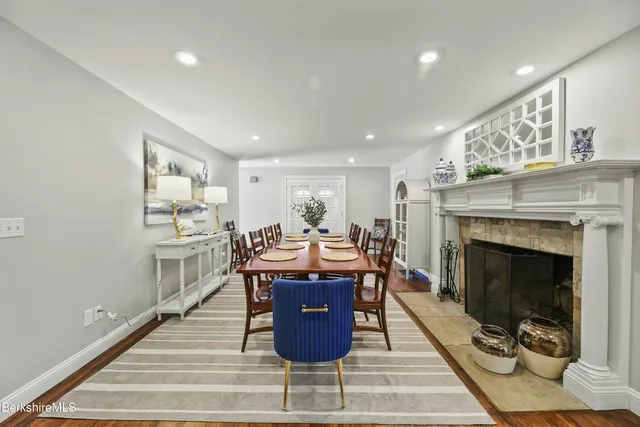 a living room with furniture a fireplace and kitchen view