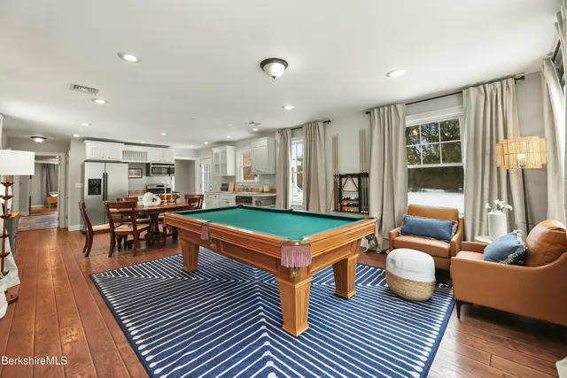 a room with lots of furniture and wooden floor