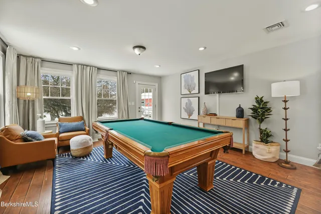 a room with furniture a flat screen tv and a large window