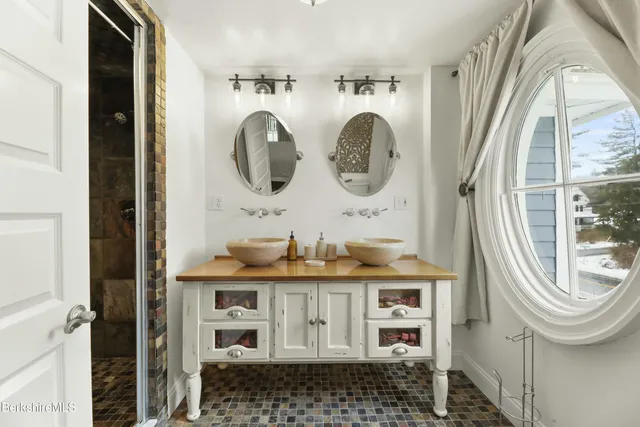 a bathroom with a granite countertop sink and a mirror
