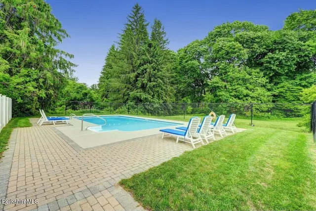 a view of a swimming pool with a yard