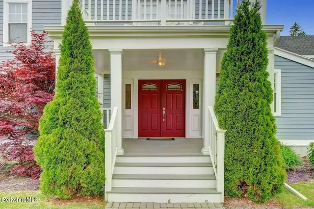 a front view of a house with plants
