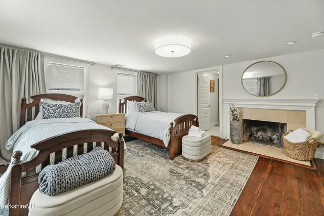 a bedroom with furniture and a fireplace