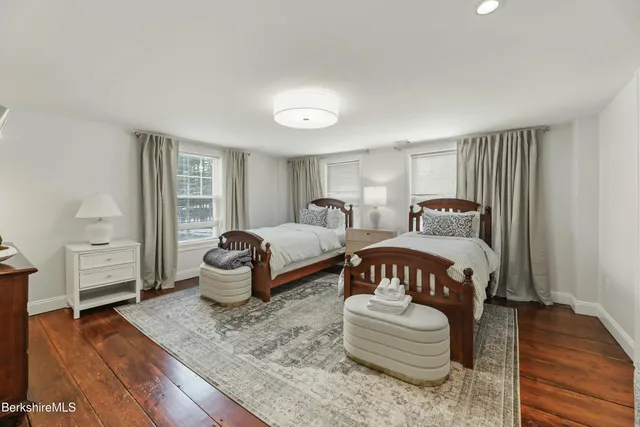 a bedroom with bed and wooden floor