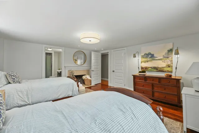 a bedroom with a bed and closet with mirror