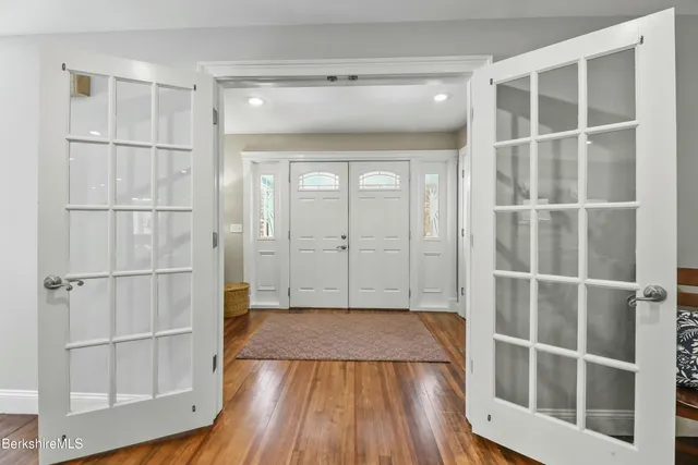 a view of a walk in closet with wooden floor