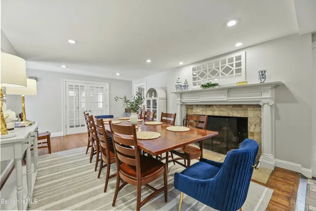 a view of a a dining room with furniture window and wooden floor
