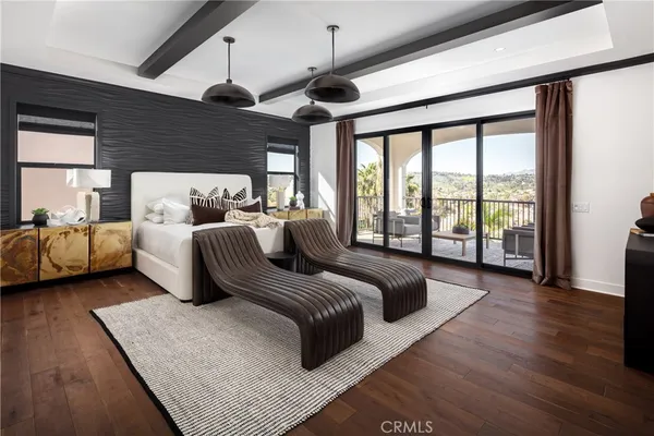 a bedroom with furniture and a large window