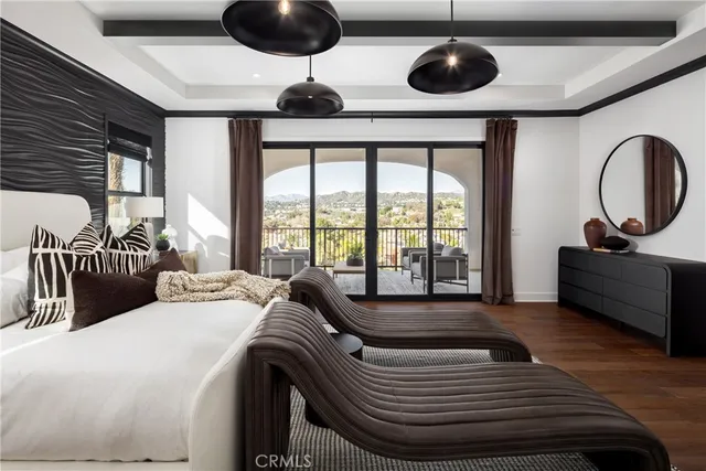 a bedroom with furniture and a large window