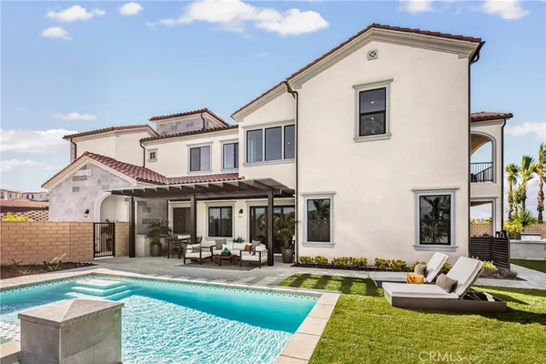 a front view of a house with swimming pool having outdoor seating