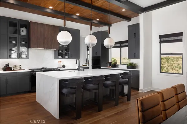 a kitchen with a sink cabinets and wooden floor