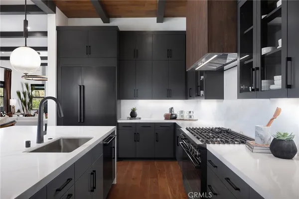 a kitchen with a sink stove and refrigerator