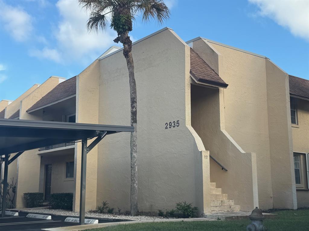 2935 Southwest 22nd Avenue, Unit 2050 Delray Beach, FL 33445 - Photo 2 of 5 a view of a house with a staircase