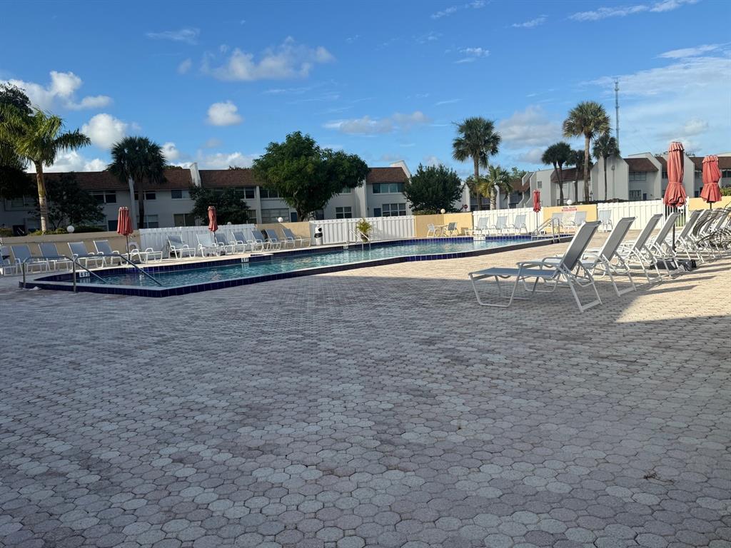 2935 Southwest 22nd Avenue, Unit 2050 Delray Beach, FL 33445 - Photo 3 of 5 a view of swimming pool with outdoor seating