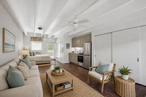 a living room with furniture and a chandelier