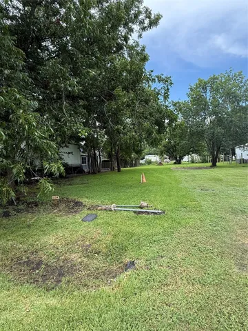 a view of a field with trees in the background