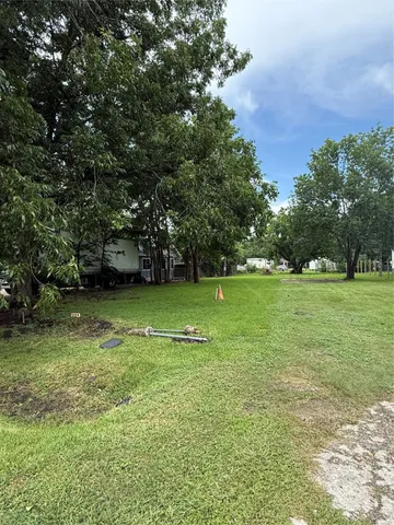 a view of a field of grass and trees