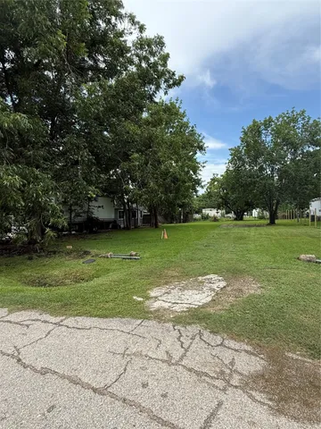 a view of a field with grass and a trees