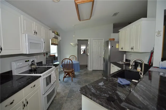 a kitchen with sink cabinets and appliances