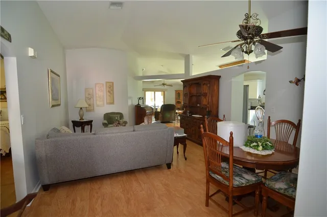 a living room with furniture and a dining table