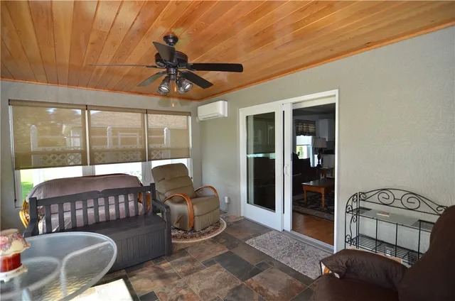 a bedroom with furniture and large window