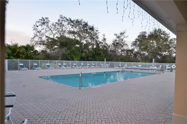 a view of a swimming pool with a yard