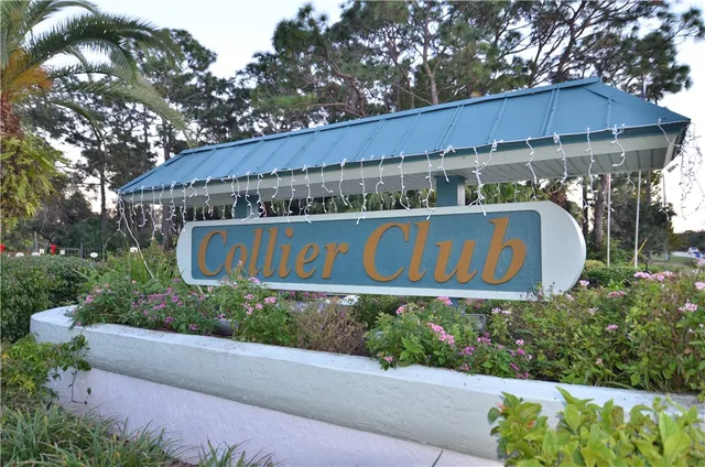 a sign that is sitting on a wooden fence