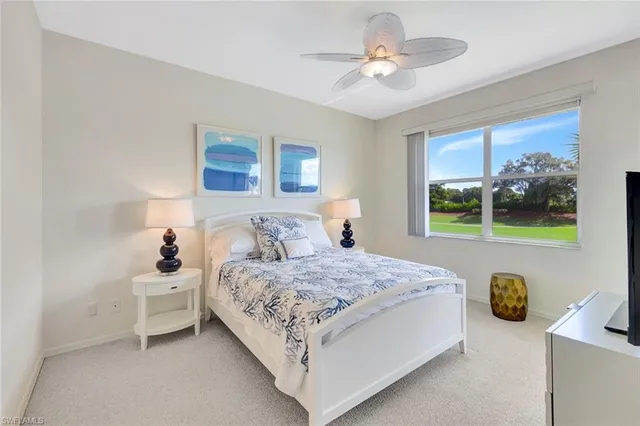 a bedroom with a bed and a tv on dresser