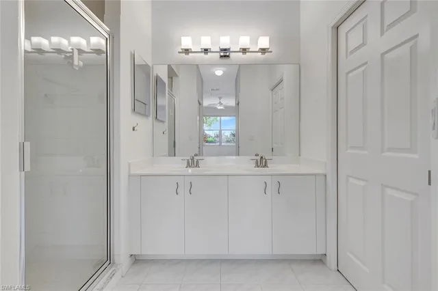 a bathroom with a sink double vanity and a mirror