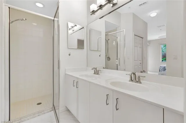 a bedroom with two beds and a chandelier