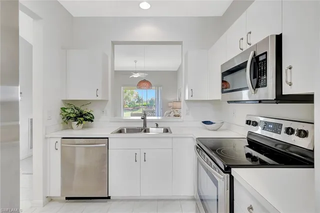 a kitchen with stainless steel appliances a refrigerator sink and cabinets