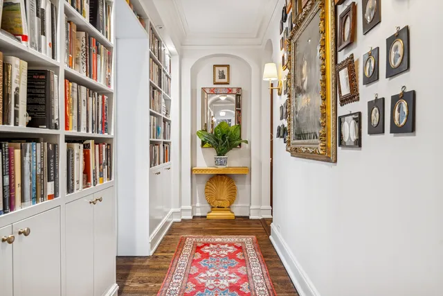 a view of a living room and a book shelf