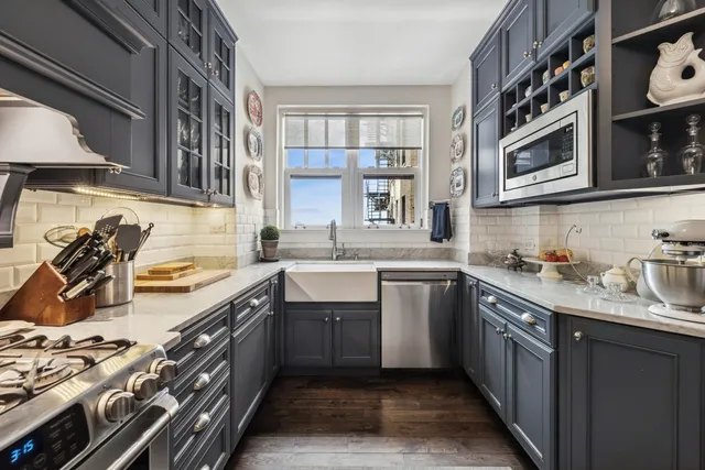a kitchen with stainless steel appliances granite countertop a sink and stove